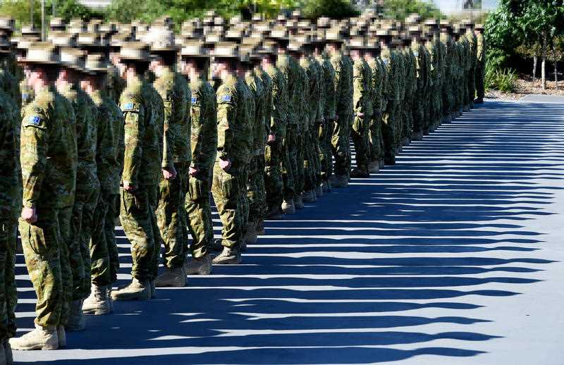 rows of Australian Defence Force personnel in khaki are seen on parade