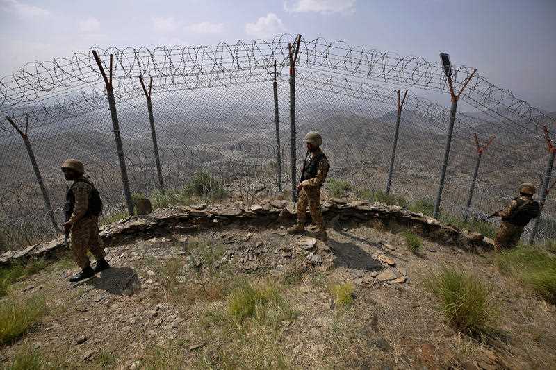Pakistan Army troops patrol along the fence on the Pakistan Afghanistan border at Big Ben hilltop post in Khyber district, Pakistan,
