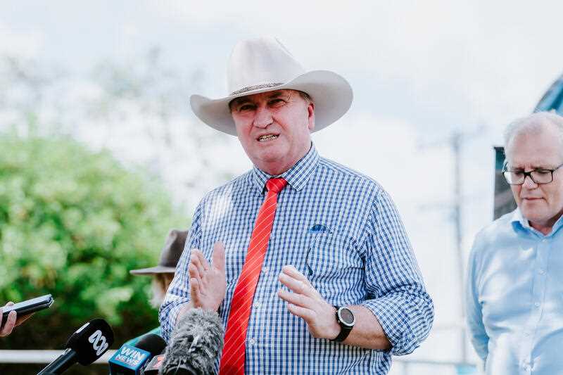 Deputy Prime Minister Barnaby Joyce, wearing a white western hat, blue check shirt and red tie is seen speaking to the media in Rockhampton, Queensland