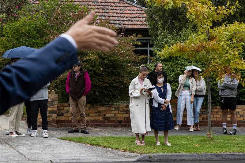 Bidders look on during a property auction