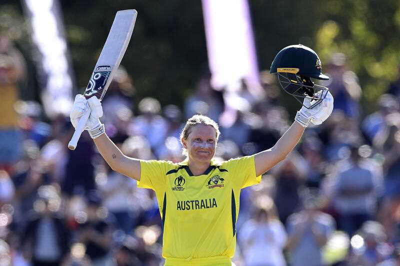 Australia's Alyssa Healy celebrates making 100 runs against England during the final of the ICC Women's Cricket World Cup match in Christchurch, New Zealand, Sunday, April 3, 2022