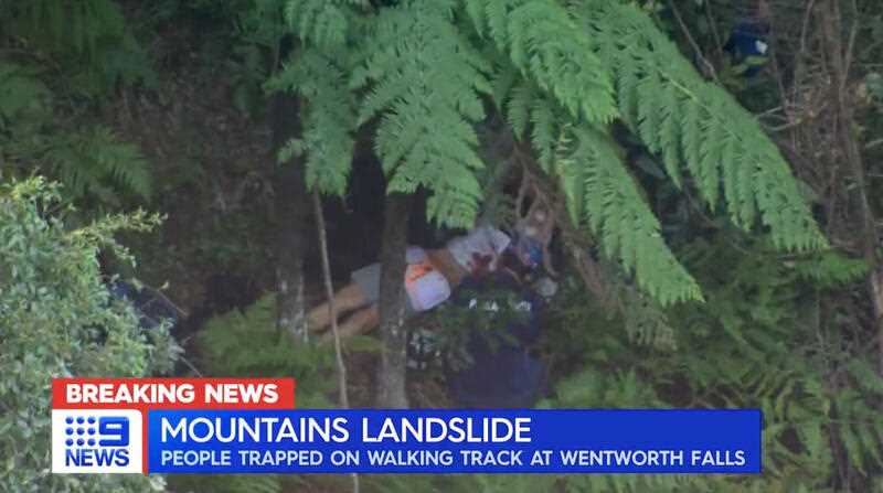 An image taken from a news broadcast and obtained on Monday, April 4, 2022, shows rescue workers attending to a person who has been involved in a landslip at Wentworth Falls, 100km west of the Sydney
