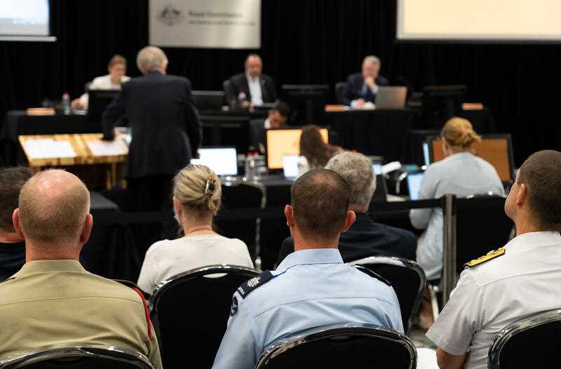 A supplied image shows scenes from inside the Royal Commission into Defence and Veteran Suicide, in Canberra