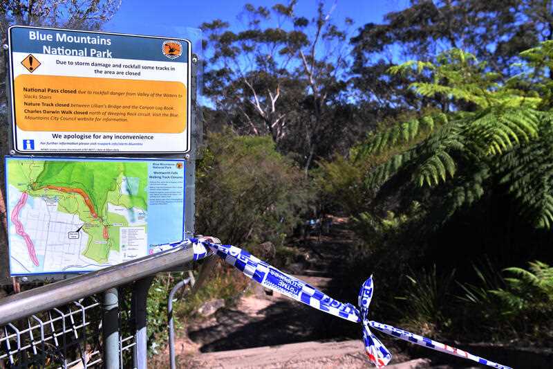 The taped off entrance to the walking track where a landslide killed 2 and injured two others at Wentworth Falls in the Blue Mountains, NSW, west of Sydney, Tuesday, April 5, 2022