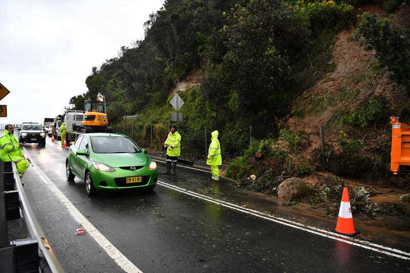 A landslide closes one lane of Lawrence Hargrave Drive at the Seacliff Bridge at Coalcliff, south of Sydney, Thursday, April 7, 2022.