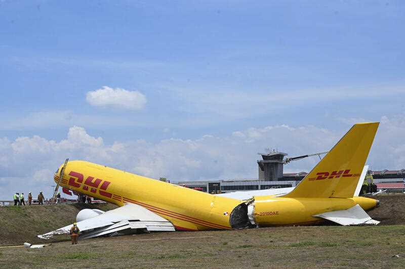A cargo jet that spun off lays broken on the runway of the Juan Santamaria International Airport in Alajuela, Costa Rica, Thursday, April 7, 2022