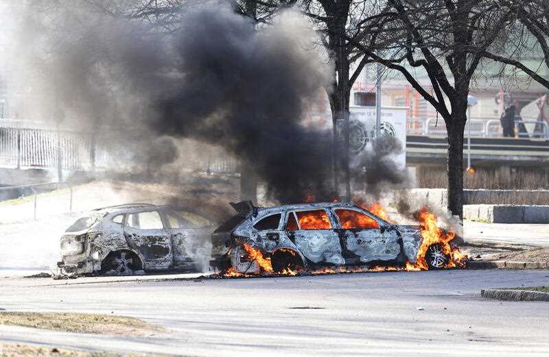 cars seen burning on the streets of a Swedish city