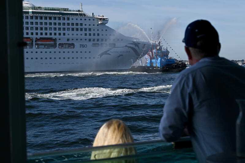 Tug boats with water cannons form a guard of honour and escort the P&O Cruises Australia flagship Pacific Explorer is it enters the Sydney Harbour, Monday, April 18, 2022