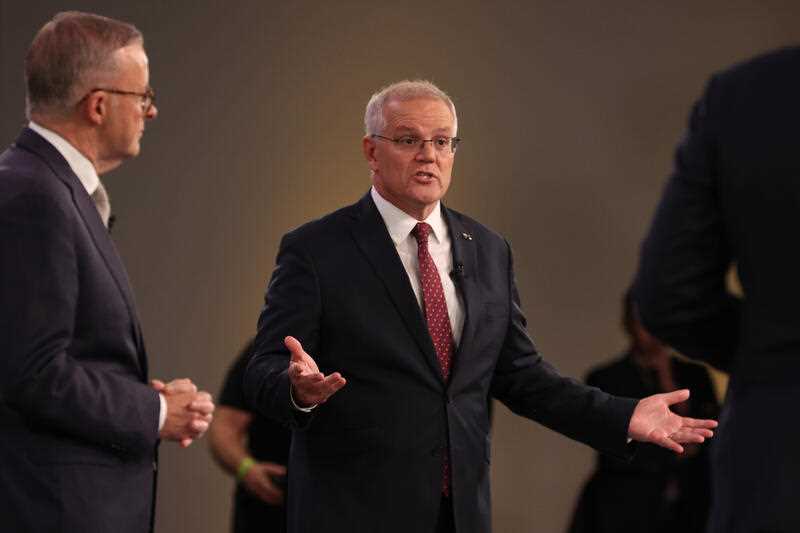 Australian Prime Minister Scott Morrison speaks as Australian Opposition Leader Anthony Albanese looks on during the first leaders' debate of the 2022 federal election hosted by Sky News at the Gabba in Brisbane, Wednesday, April 20, 2022.