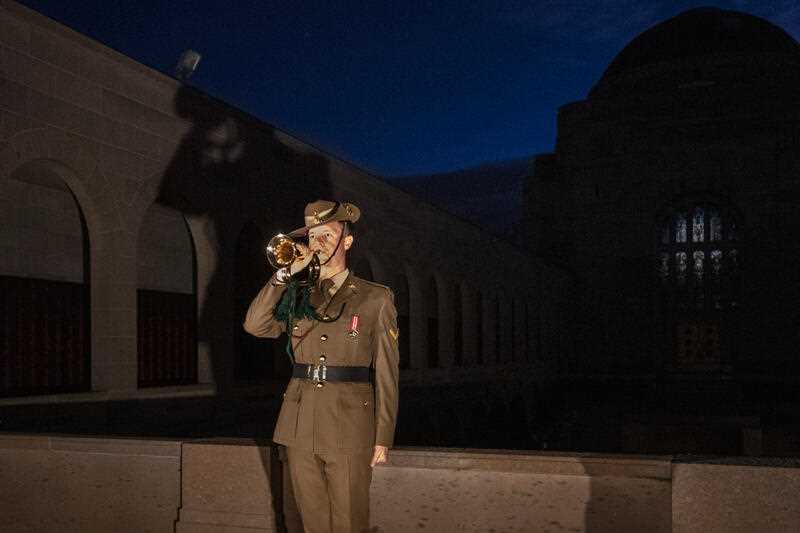 a bugler playing ‘The Last Post’ during the Anzac Day Dawn Service at the Australian War Memorial in Canberra on Monday 25 April 2022