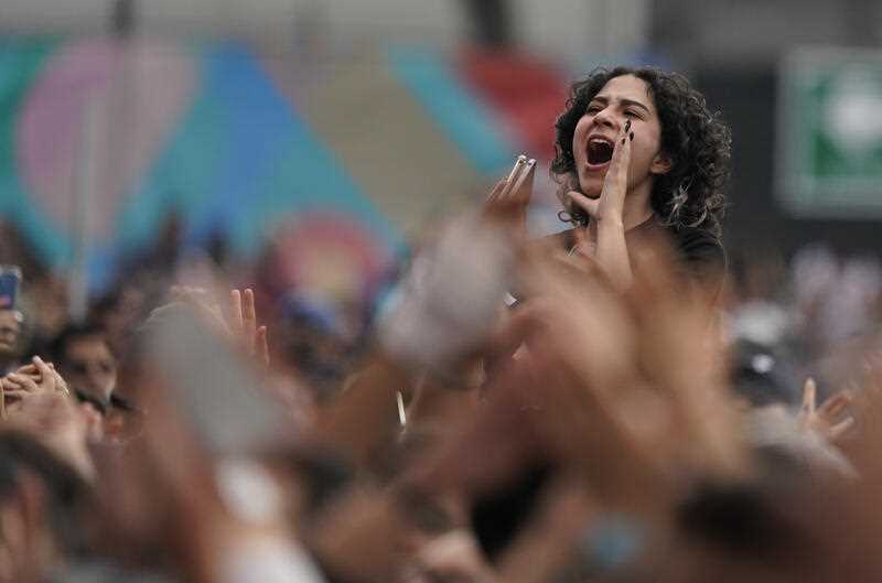 A fan cheers at a music festival.