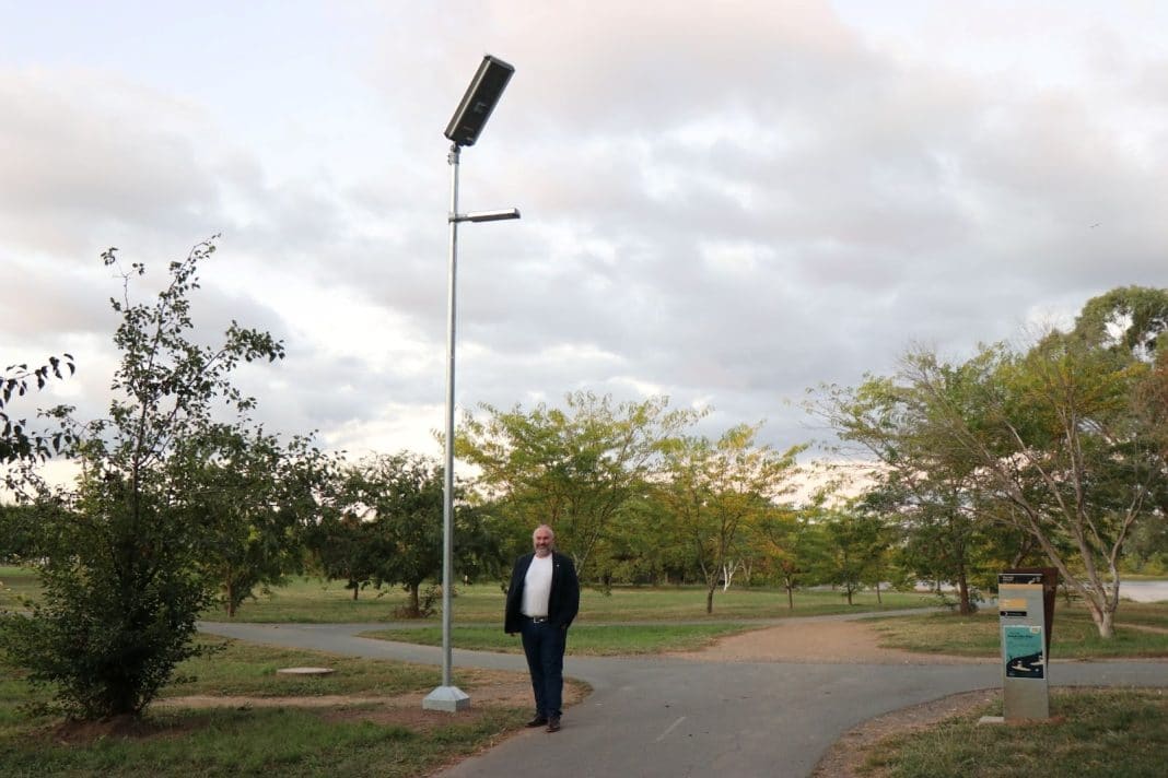 Andrew Braddock MLA stands under one of Yerrabi Pond’s new solar lights. Photo provided.