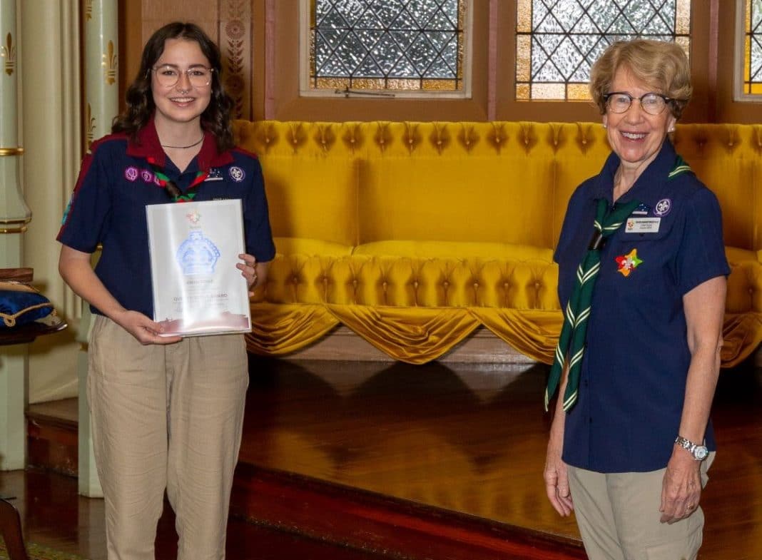 Young female scout leader receiving Queen's Scout Award from the Governor of NSW Margaret Beazley