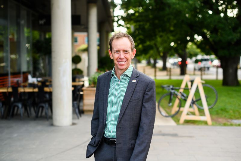 ACT Greens minister Shane Rattenbury is seen outdoors, smiling at the camera