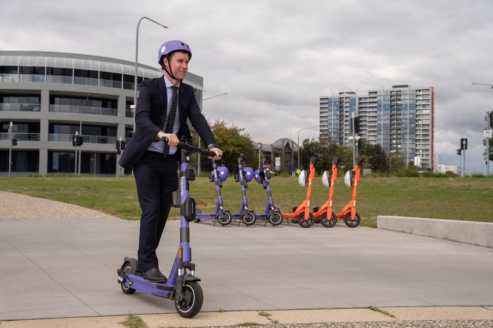 Chris Steel, ACT Minister for City and Transport Services, rides an e-scooter. Photo provided.