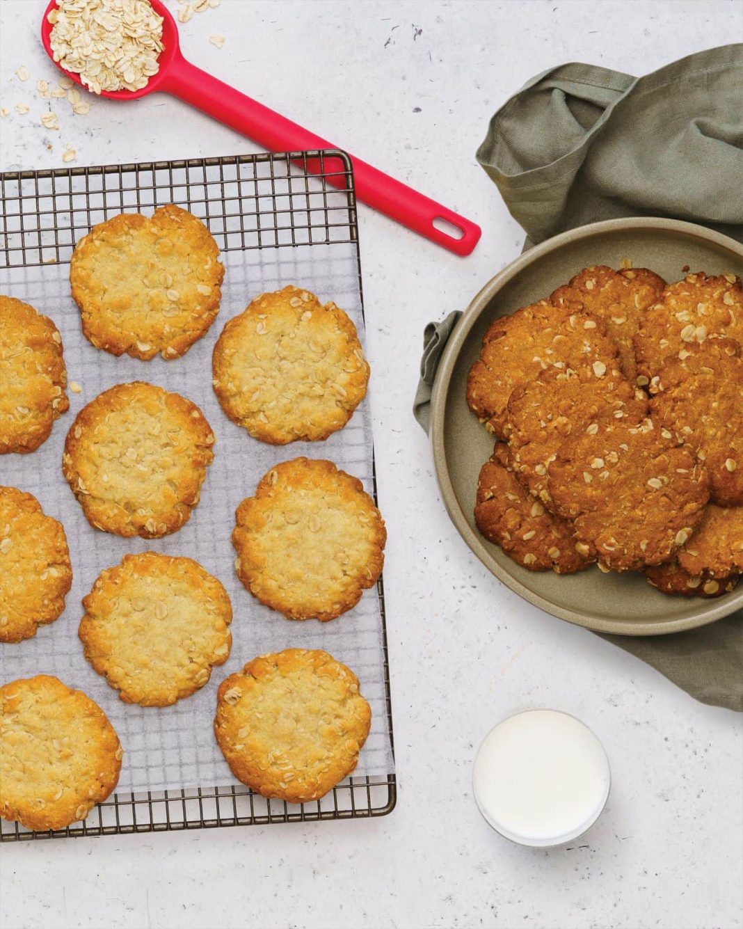 Anzac biscuits on a cooling tray and in a biscuit tin