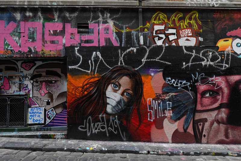 Coronavirus inspired street art is seen in Hosier Lane, Melbourne, Friday, April 17, 2020.