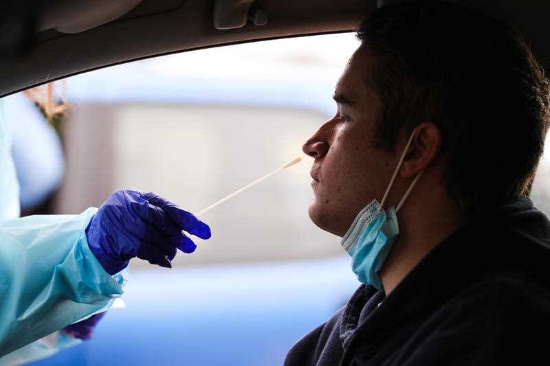 A man is seen getting a swab at a COVID-19 pop up drive through site