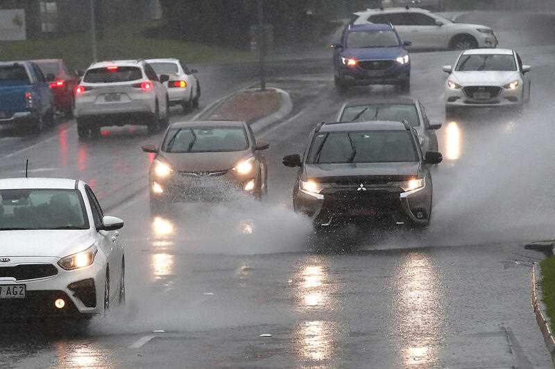 Cars drive in heavy rain in Logan, Queensland