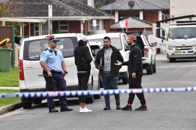 Police speak with residents at the scene of a shooting in Greenacre, Sydney, Thursday, April 28, 2022. A man shot dead in Sydney's southwest overnight is believed to be crime figure Mahmoud 'Brownie' Ahmad, who was recently released from jail.