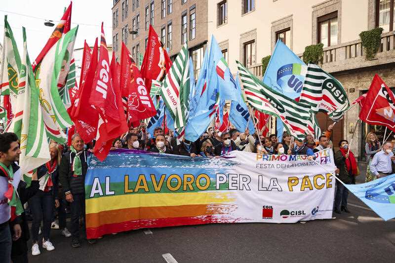 Demonstrators participate in a May Day march organized by trade unions in Milan, Italy, Sunday, May 1, 2022