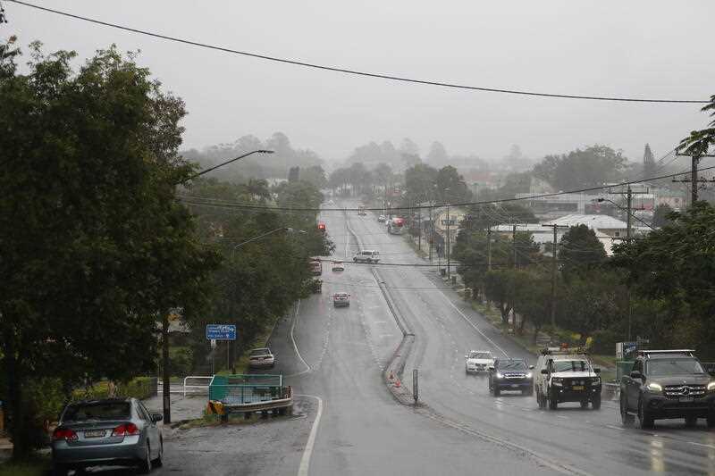 Traffic is seen driving on Ballina Road in Lismore as rain falls