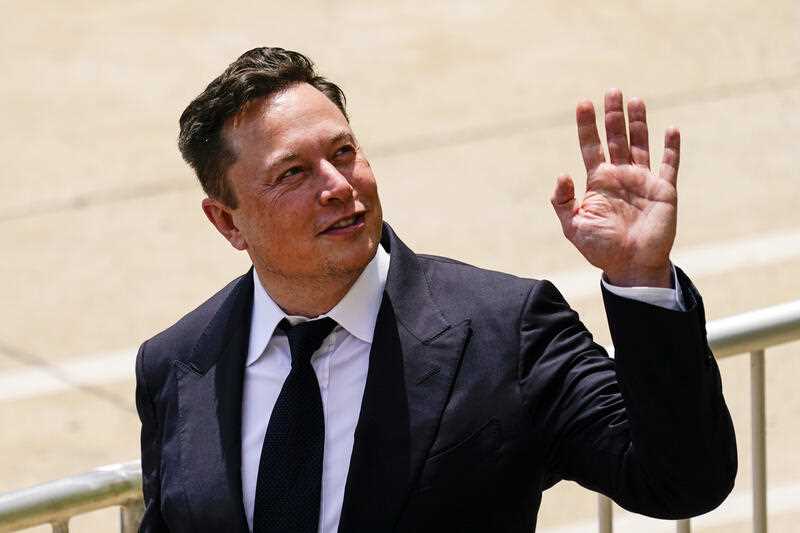 US billionaire Elon Musk is seen smiling and waving