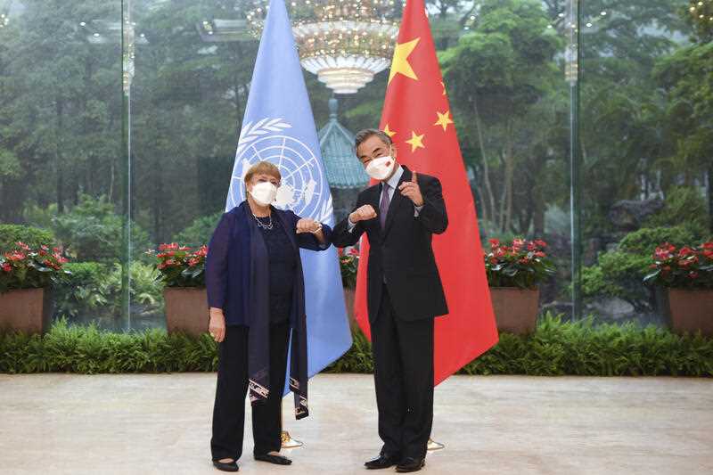 Chinese Foreign Minister Wang Yi, right, meets with the United Nations High Commissioner for Human Rights Michelle Bachelet in Guangzhou