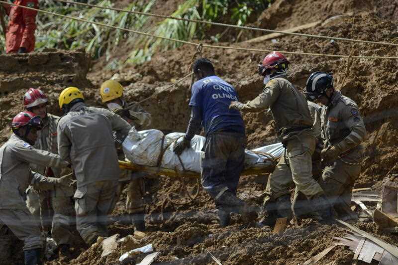 Firefighters carry a victim at a site of a landslide caused by heavy rains, in the Jardim Monteverde neighborhood, in Jaboatao dos Guararapes, Brazil, 29 May 2022