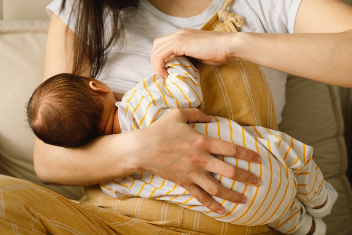 Mother breastfeeding newborn baby