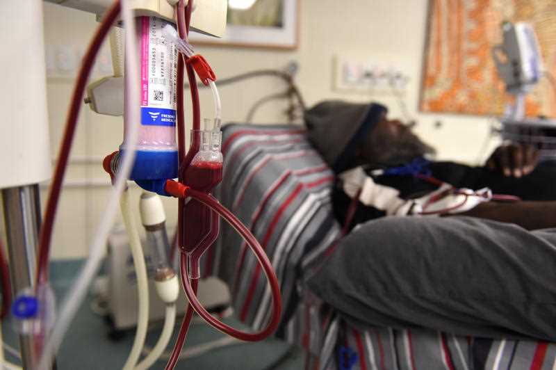 a man is seen receiving dialysis treatment