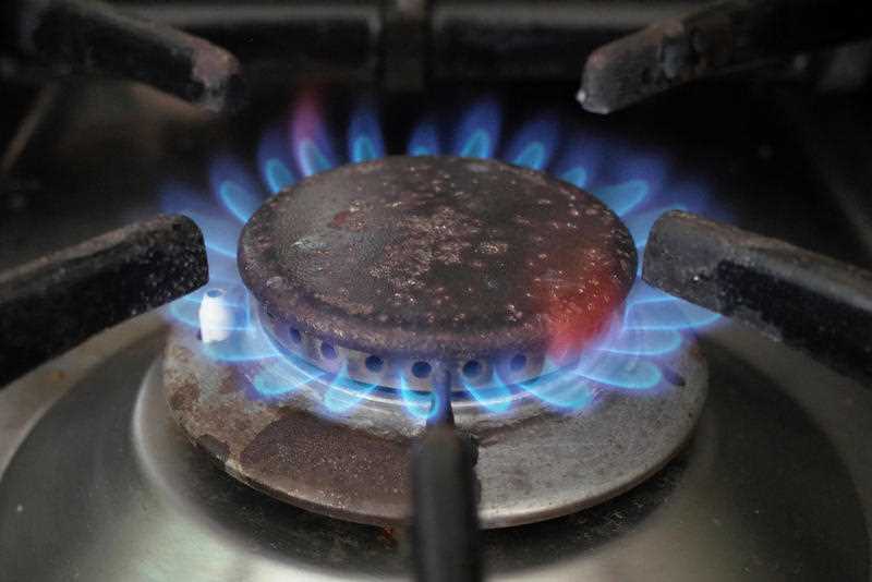 A gas burner is lit on a bench top cooker in Canberra
