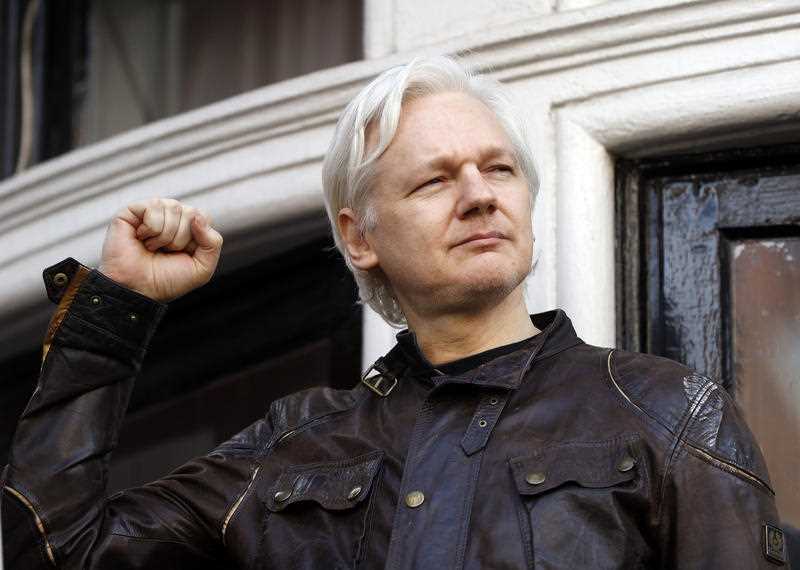 In this May 19, 2017 file photo, WikiLeaks founder Julian Assange greets supporters outside the Ecuadorian embassy in London, where he has been in self imposed exile since 2012.