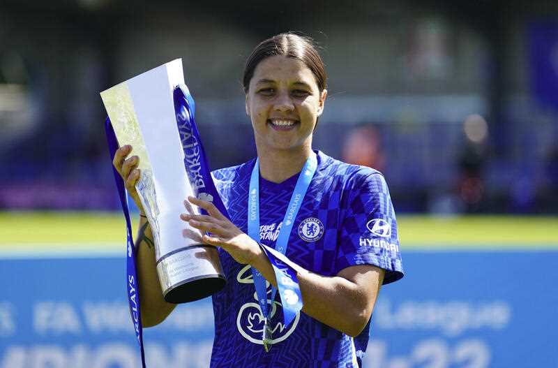 Chelsea's Sam Kerr celebrates with the FA Women's Super League trophy after defeating Manchester United, at Kingsmeadow Stadium, London, Sunday May 8, 2022