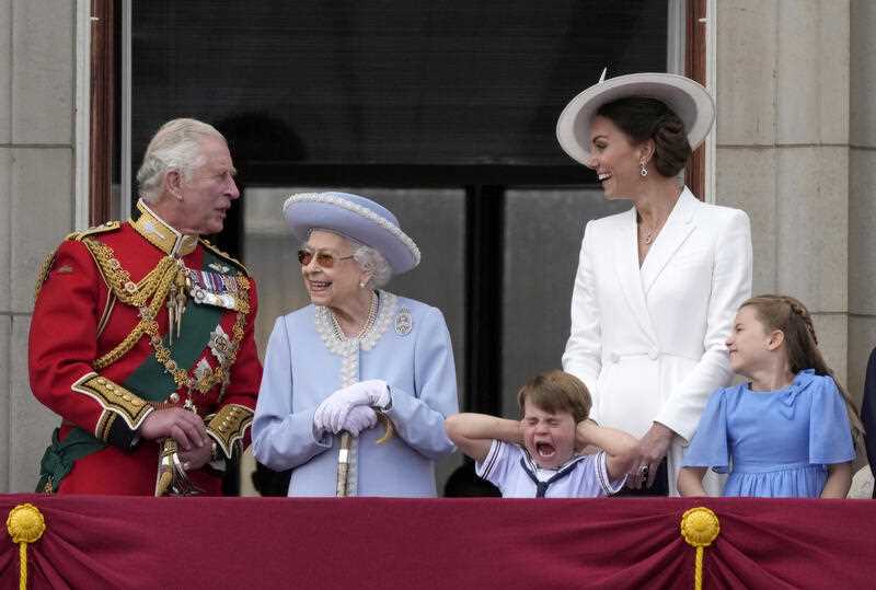 Britain's Prince Charles, left, with Queen Elizabeth II, Prince Louis her grandson, covering his ears with his hands, next to his mother Kate Duchess of Cambridge and Princess Charlotte her daughter, at right, stand on the balcony of Buckingham Palace, London