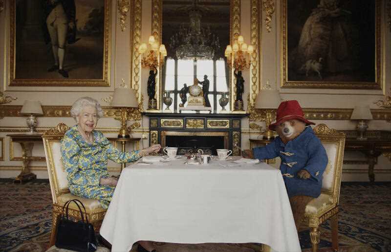 Britain's Queen Elizabeth II and Paddington Bear have cream tea at Buckingham Palace, in London, taken from a film that was shown at the BBC Platinum Party at the Palace