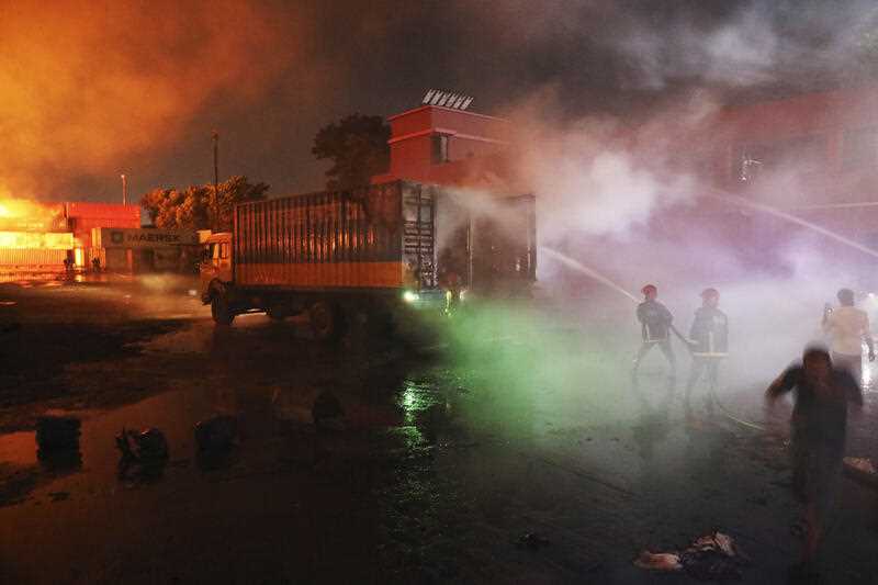 Firefighters work to contain a fire that broke out at the BM Inland Container Depot, a Dutch-Bangladesh joint venture, in Chittagong, 216 kilometers (134 miles) southeast of capital, Dhaka, Bangladesh, early Sunday, June 5, 2022