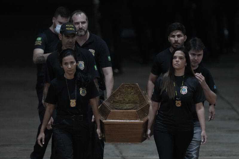 Federal police officers arrive with recovered human remains believed to be of the Indigenous expert Bruno Pereira of Brazil and freelance reporter Dom Phillips of Britain, at the Federal Police hangar in Brasília, Brazil, Thursday, June 16, 2022