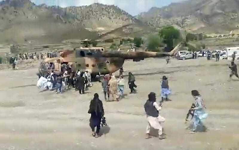 Taliban fighters secure a government helicopter to evacuate injured people in Gayan district, Paktika province, Afghanistan, Wednesday, June 22, 2022
