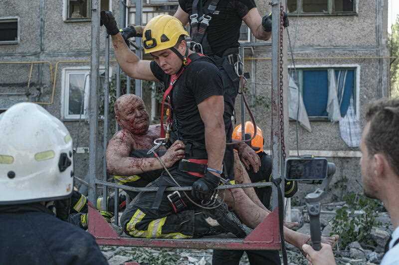Ukrainian rescue workers evacuate a wounded person after shelling at a residential area in Mykolaiv, southern Ukraine, 29 June 2022