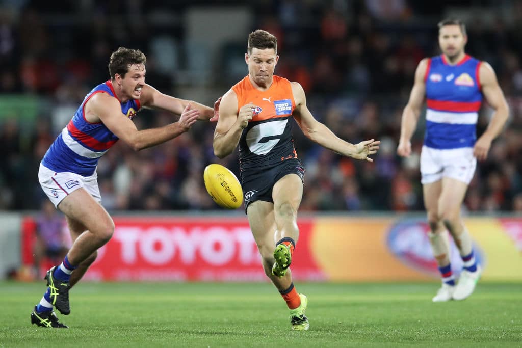 CANBERRA, AUSTRALIA - APRIL 23: Toby Greene of the Giants kicks during the round six AFL match between the Greater Western Sydney Giants and the Western Bulldogs at Manuka Oval on April 23, 2021 in Canberra, Australia. (Photo by Matt King/AFL Photos/via Getty Images )