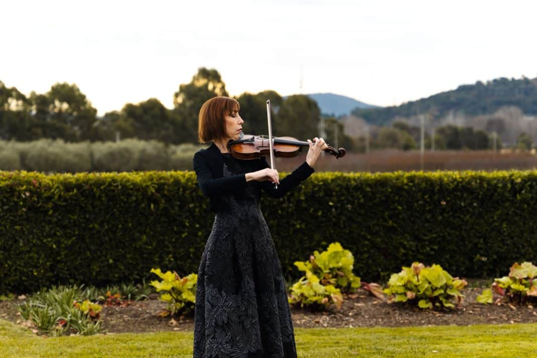 elegant female violinist playing outdoors at Pialligo Estate market garden
