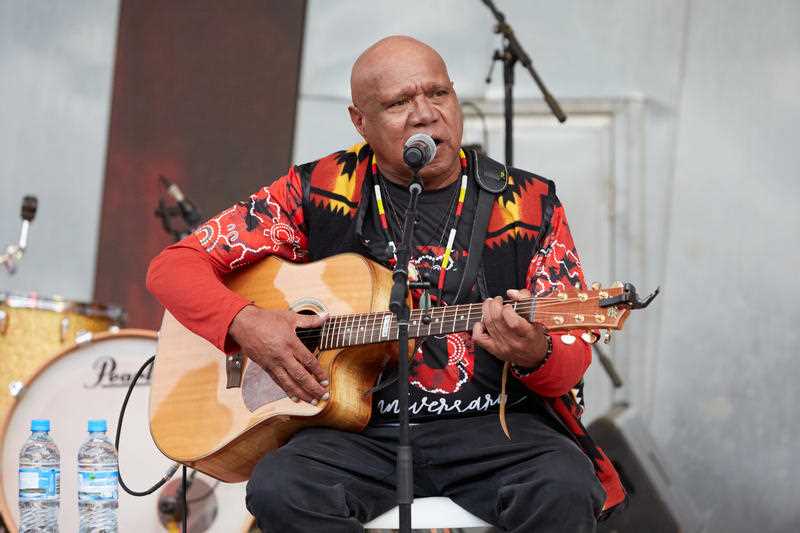 Archibald 'Archie' Roach performs during the annual Long Walk celebrations before the Dreamtime at the 'G clash between Essendon and Richmond in Melbourne, Saturday, May 25, 2019
