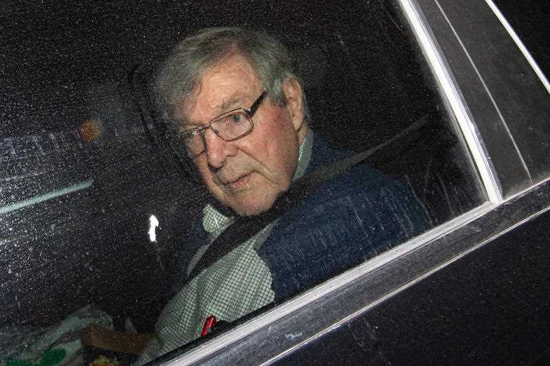 Cardinal George Pell is seen in the passenger seat of a car