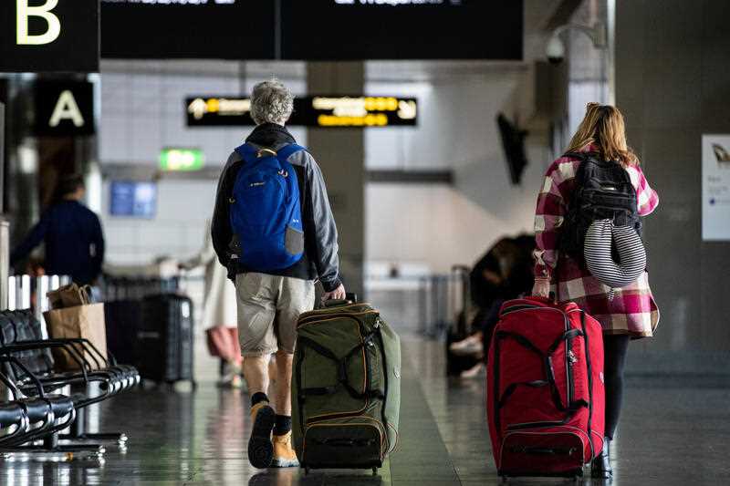 Travellers walk through the Airport in Melbourne