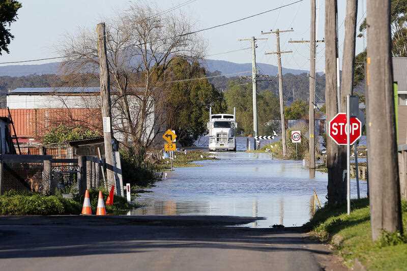 Floodwaters block the road in Maitland NSW, Saturday 9 July 2022