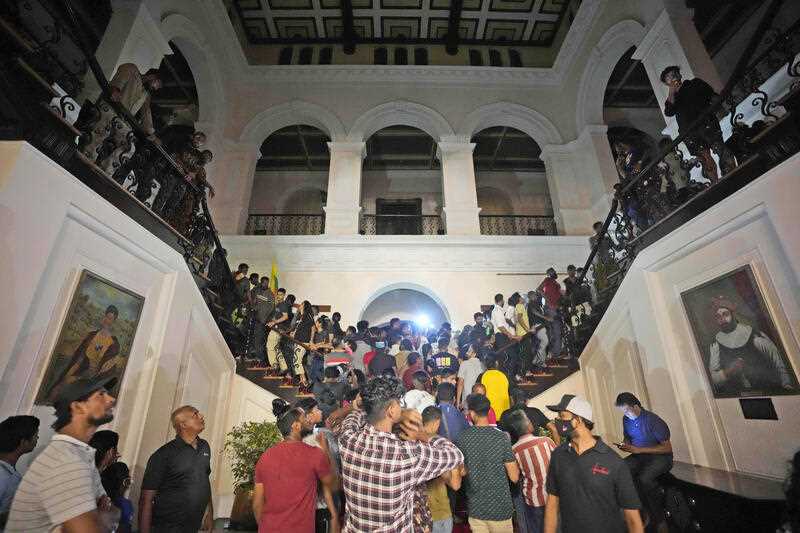 Protesters storm in at the Sri Lankan president's official residence, in Colombo, Sri Lanka , Saturday, July, 9, 2022