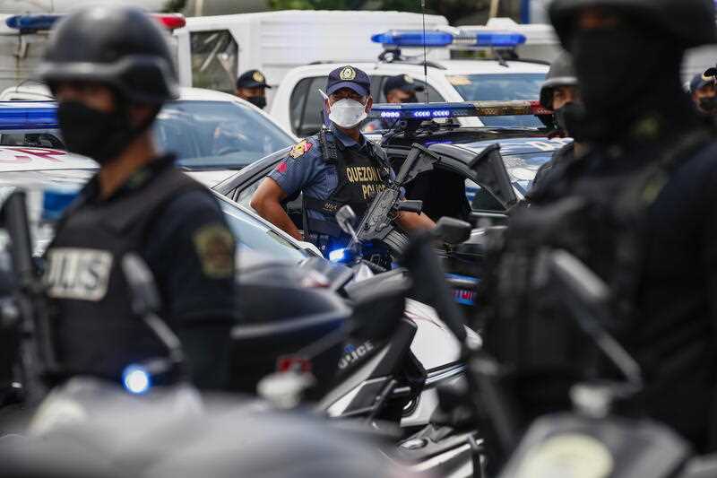 Philippine police stand in formation beside their vehicles during an inspection at a police camp in Quezon City, Metro Manila, Philippines 19 July 2022