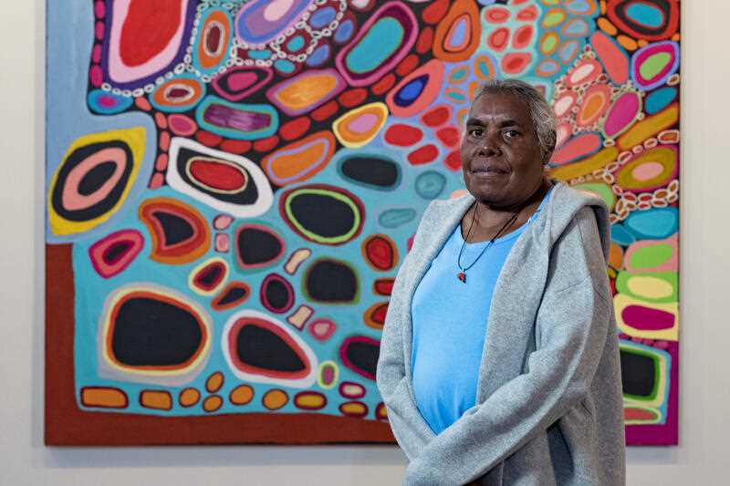 ornington Island artist Dorothy Gabori with Our Mother’s and Grandmother’s Country, which she created with Amanda Jane Gabori, at the The National Museum, Canberra