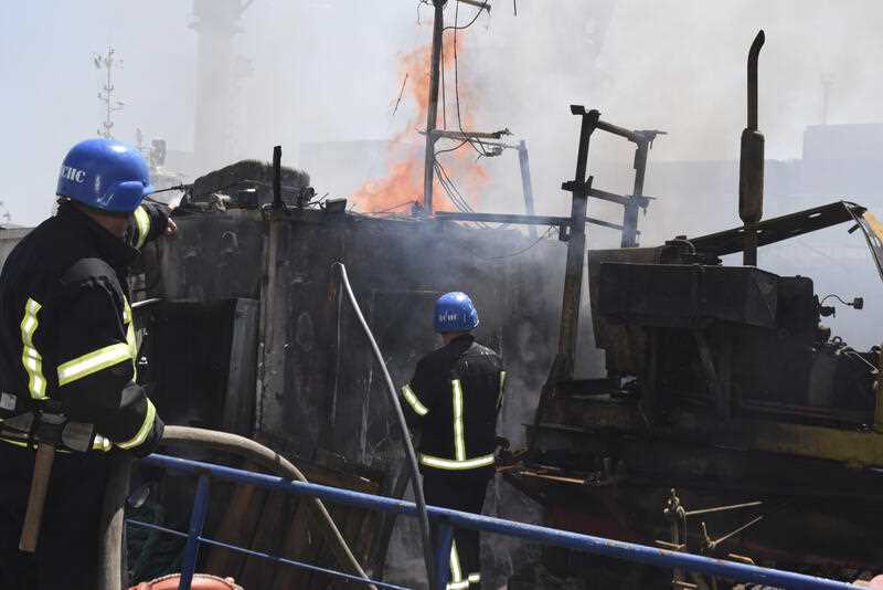 firefighters put out a fire in a port after a Russian missiles attack in Odesa, Ukraine, Saturday, June 5, 2022